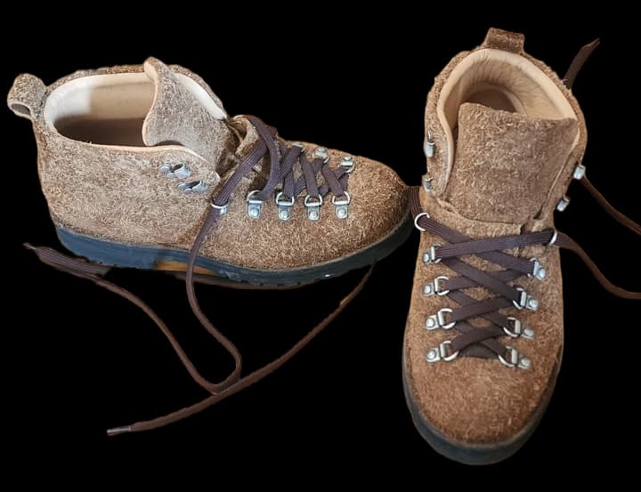 Brown suede hiking boots with dark laces and metal eyelets