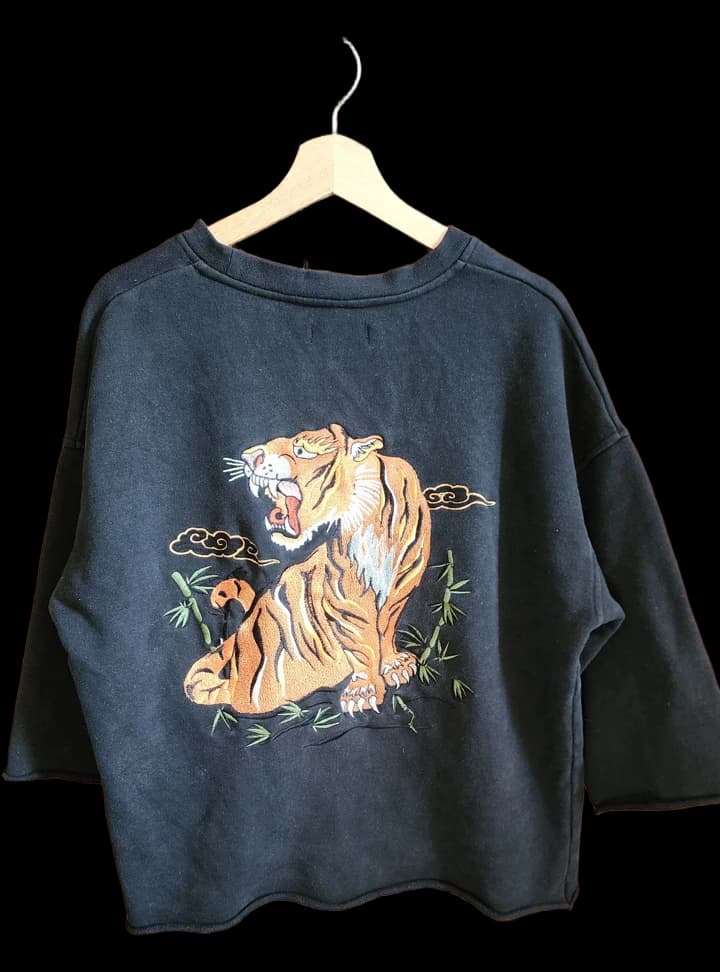 Black T-shirt with an orange tiger and bamboo graphic