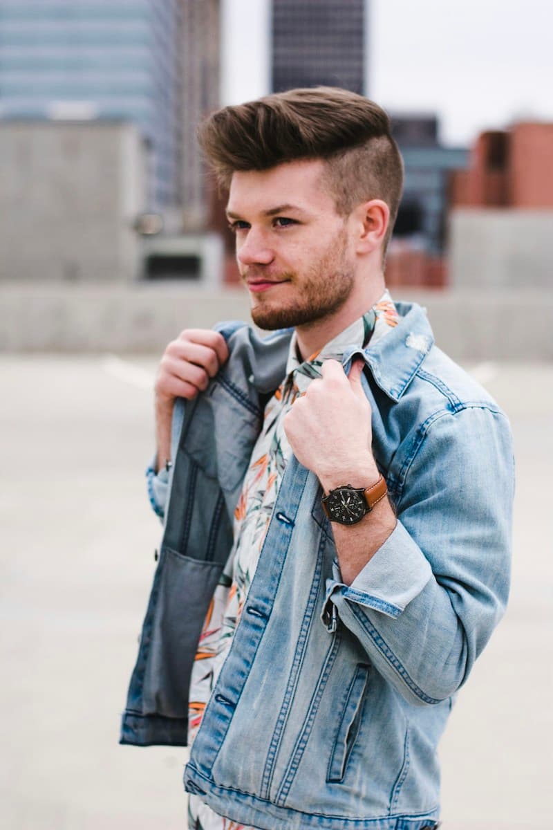 A casual denim jacket styled with a patterned shirt