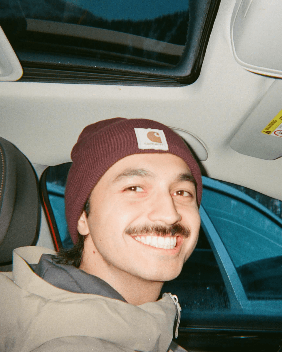 Adam, Fitr co-founder, smiling in a burgundy beanie